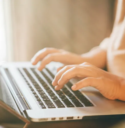 woman typing on a laptop