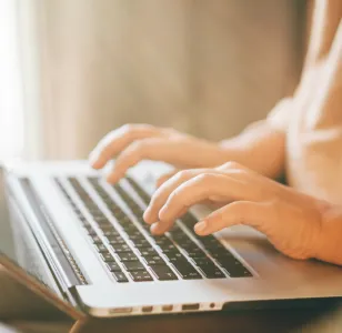 woman typing on a laptop