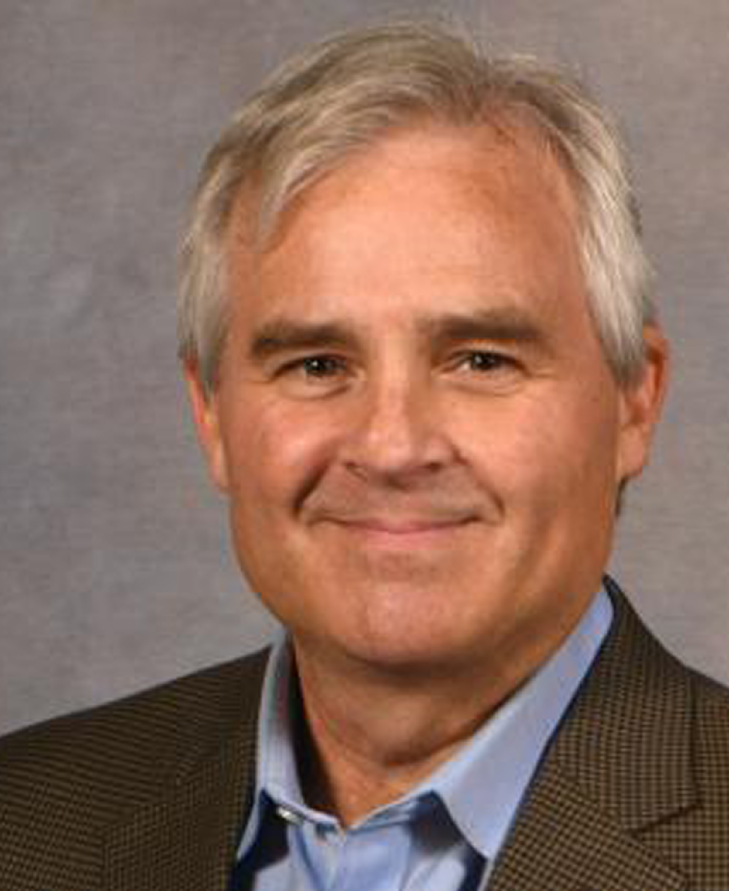 Brian Roe in gray blazer