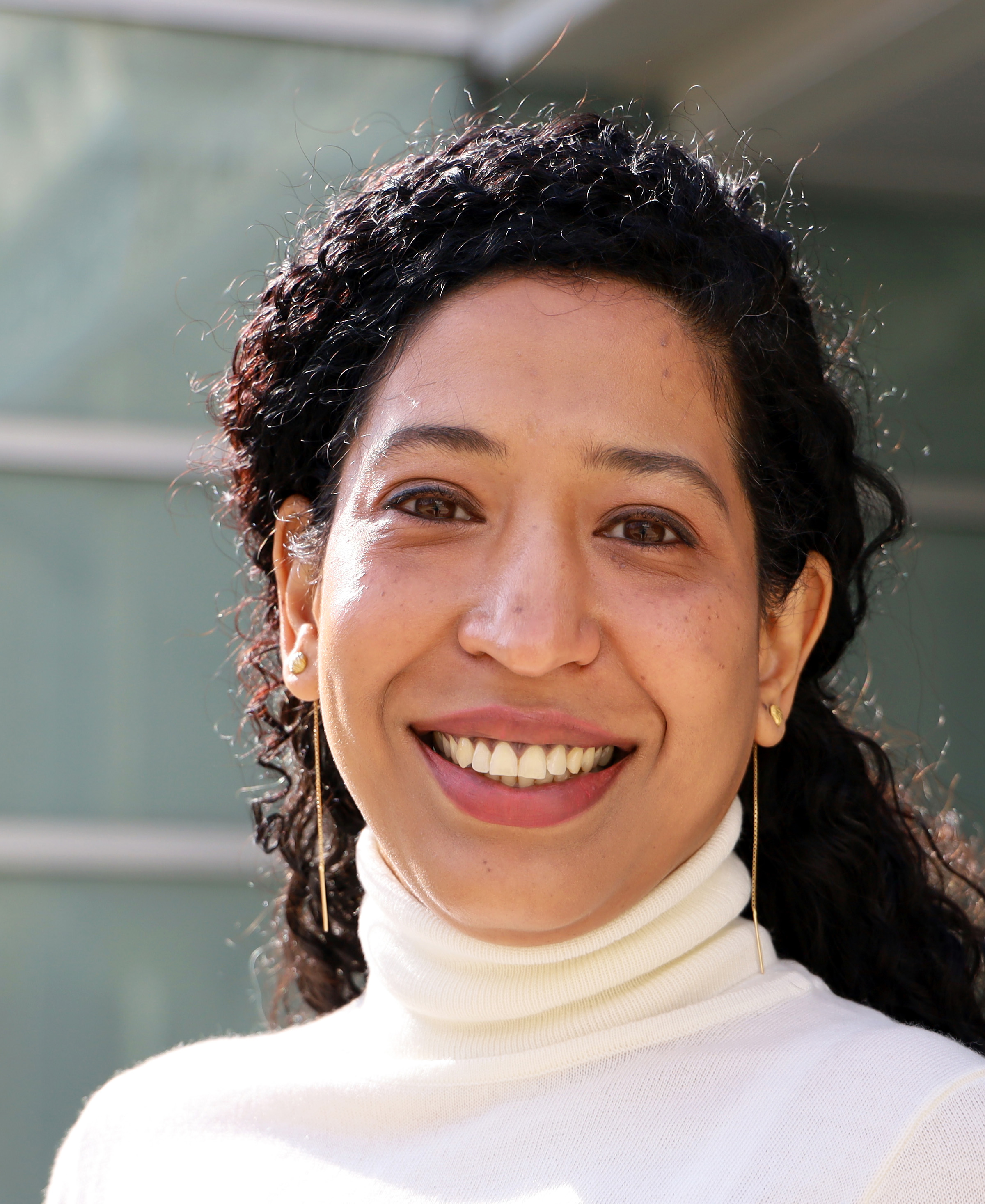 Parvati Singh in white turtle neck shirt