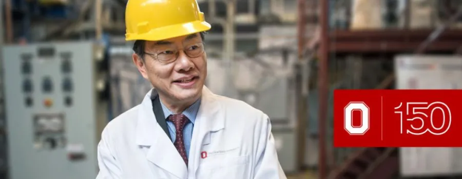 Liang-Shih Fan wearing a yellow hardhat and white lab coat.