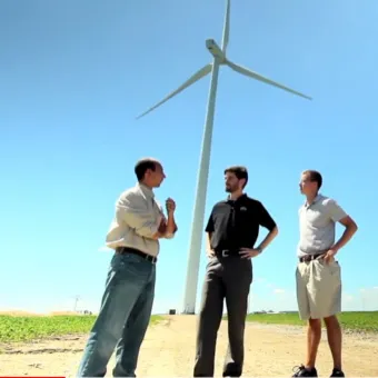 men standing in front of windmill