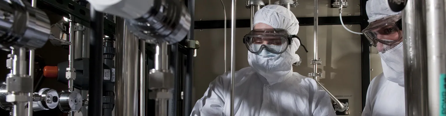 Researchers in clean room PPE