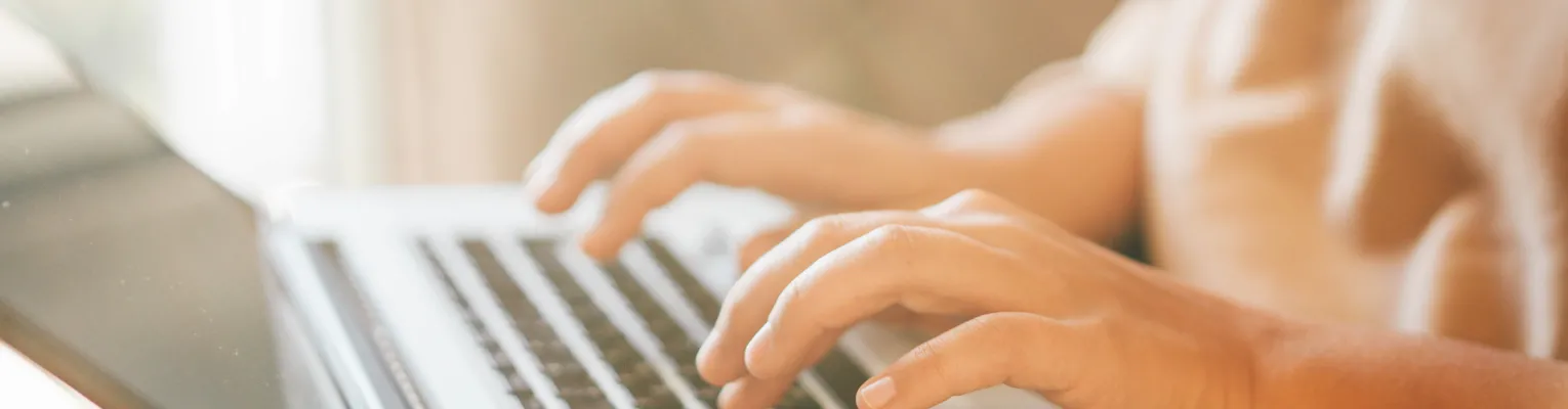 woman typing on a laptop