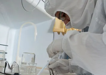 Person in clean room with PPE