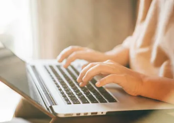 woman typing on a laptop
