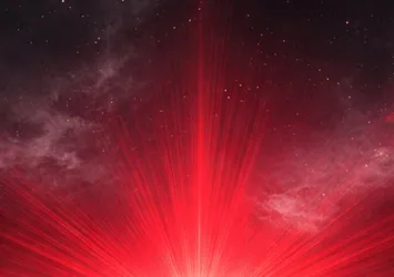 burst of red light over a planetary horizon with outer space in the background