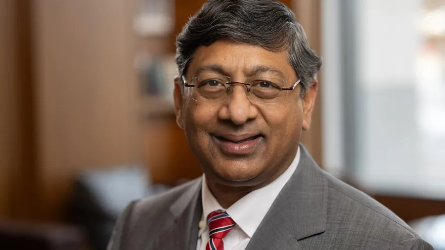 Ravi V. Bellamkonda in a gray suit and red tie