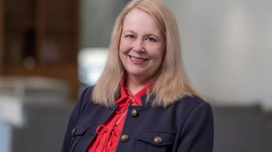 Christine Hamble in red shirt and black jacket