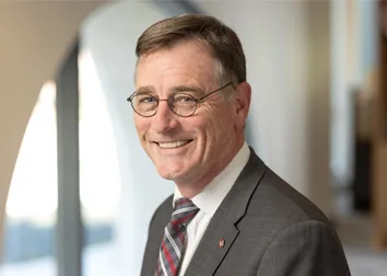 John Horack in a gray suit with a red and gray tie