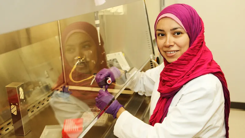 women researcher with headdress practicing biosaftey guidelines