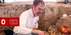 Clark Spencer Larsen of Anthropology excavating human bones