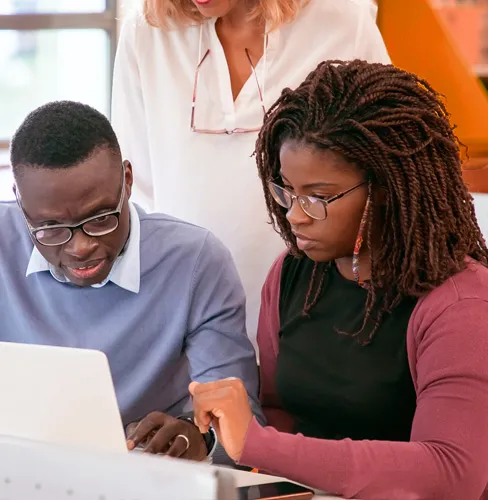 Three people looking at computer screen