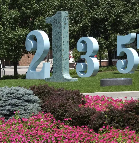 Large number sculptures in the middle of a garden