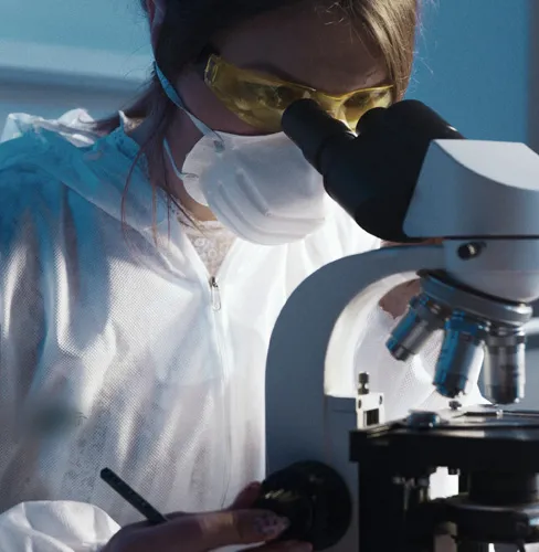 girl looking through microscope