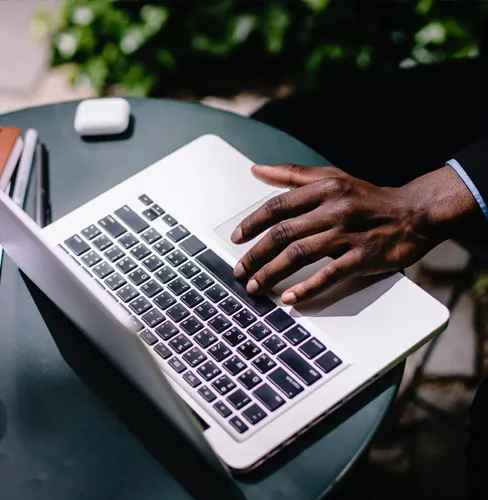 man typing on a laptop