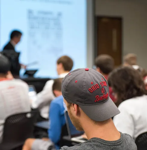 classroom of students with a focus on a students ohio state hat