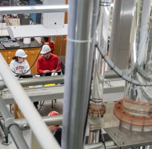 two researchers in hard hats in a lab