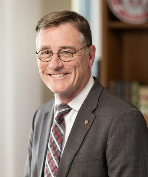 John Horack in a gray suit with a red and gray tie