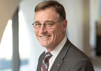 John Horack in a gray suit coat and red and gray tie